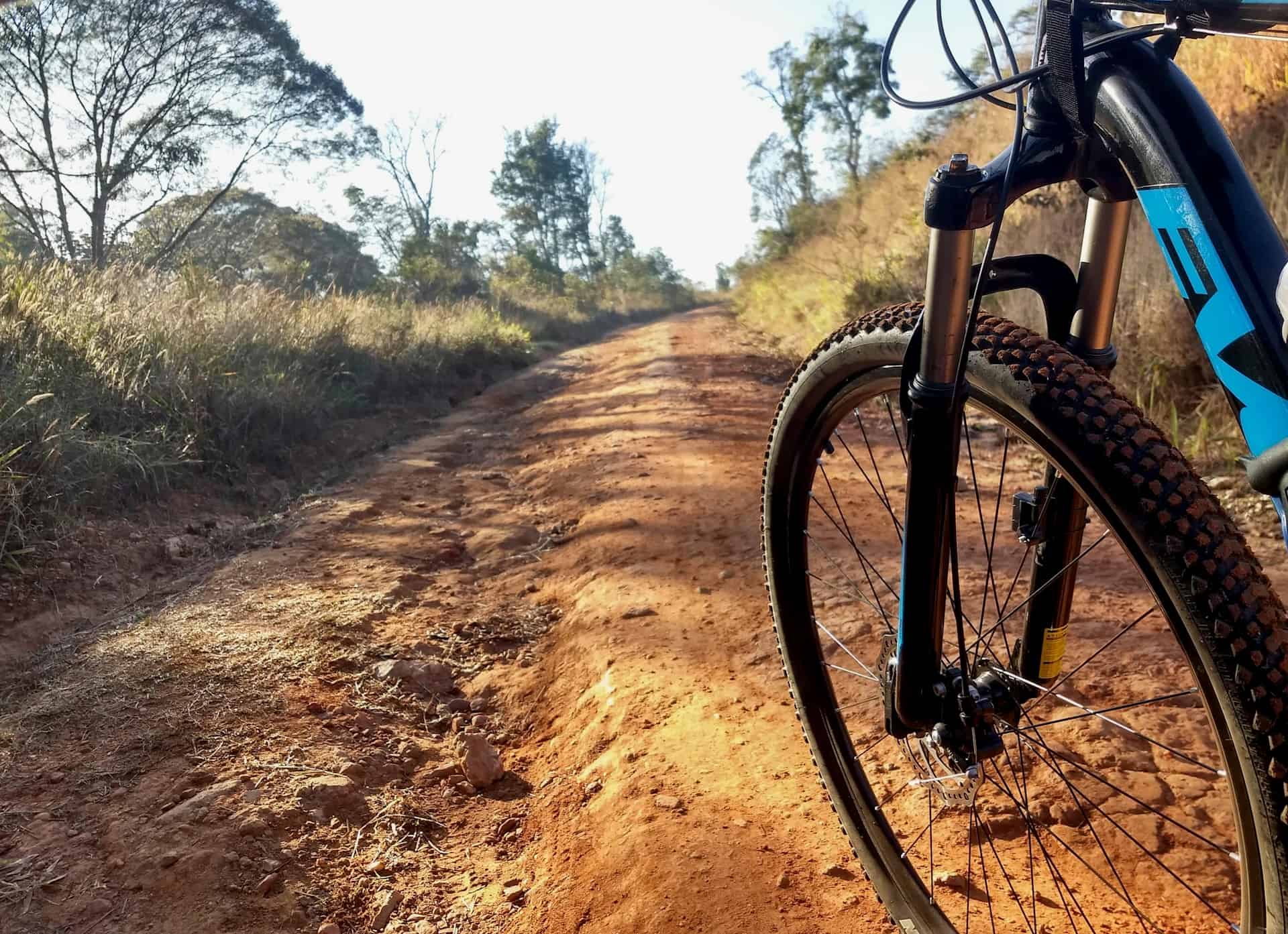 Bike on rugged dirt trail in nature setting, promoting outdoor recreation and healthy lifestyle.